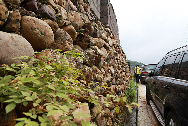 油石鄉(xiāng)梅嶺小學(xué)路口較窄，車(chē)隊(duì)只能停在路邊，步行上去